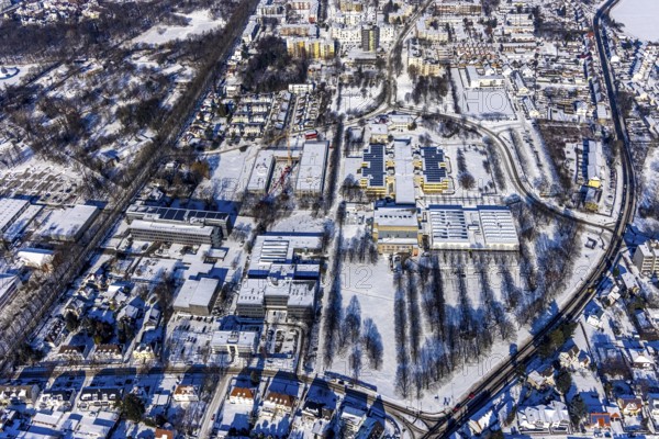 Aerial view, construction site Berliner Allee building with further education centre, educational campus, Geschwister-Scholl-Gymnasium, Werner von Siemens Gesamtschule, Hansa Berufskolleg, Hellweg Berufskolleg, Erich Göpfert civic hall, Königsborn, Unna, Ruhr area, North Rhine-Westphalia, Germany, education, educational institution, DE, Europe, teaching institute, aerial view, aerial photography, aerial photography, snow, school, overview, bird's-eye view, winter, onset of winter, winter landscape, birds-eyes view, overview