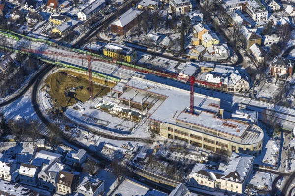 Aerial view, construction site new building shopping centre, former site Mühle Bremme, Unna, Ruhr area, North Rhine-Westphalia, Germany, construction work, construction area, construction site, building plots, construction measure, construction project, construction site, DE, shopping centre, Europe, Kantstraße, aerial view, aerial photography, aerial photography, new building, postal stairs, snow, overview, bird's eye view, winter, onset of winter, winter landscape, birds-eyes view, overview