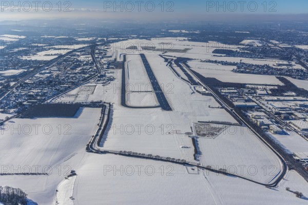 Aerial photo, Dortmund airport, Maßen, Unna, Ruhr area, North Rhine-Westphalia, Germany, DE, Europe, flight emission, airport, aircraft noise, airfield, runway, aerial photo, aerial photography, aerial photography, planespotter viewpoint, snow, runway, overview, bird's-eye view, winter, onset of winter, winter landscape, birds-eyes view, overview