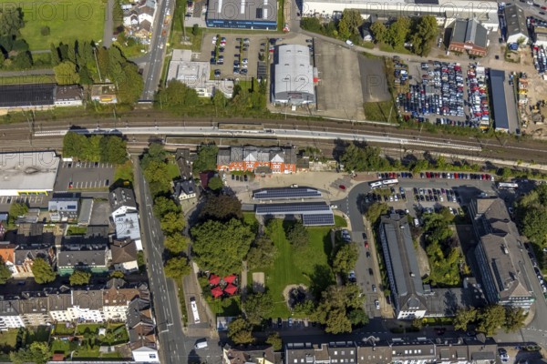 Aerial view, Schwelm railway station with red station building and bus station with solar roof and YNS Arena Eventhalle Schwelm in Schwelm, Ruhr area, North Rhine-Westphalia, Germany, railway station, station forecourt, bus station, DE, Deutsche Bahn AG, Europe, central station, main station, culture, art, aerial view, aerial photography, aerial photography, Schwelm, overview, event location, event venue, bird's-eye view, ZOB, birds-eyes view, cultural use, overview