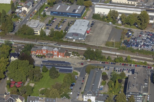 Aerial view, Schwelm railway station with red station building and bus station with solar roof and YNS Arena Eventhalle Schwelm in Schwelm, Ruhr area, North Rhine-Westphalia, Germany, railway station, station forecourt, bus station, DE, Deutsche Bahn AG, Europe, central station, main station, culture, art, aerial view, aerial photography, aerial photography, Schwelm, overview, event location, event venue, bird's-eye view, ZOB, birds-eyes view, cultural use, overview