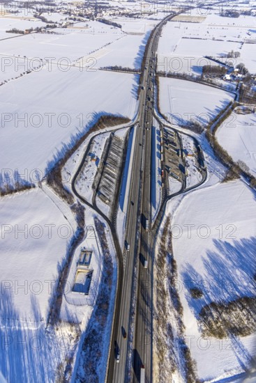 Aerial photo, Ostönner Grund rest area on the A44 motorway, snow, winter, rest areas, trucks, Röllingsen, Soest, Soester Börde, North Rhine-Westphalia, Germany, Soester, Börde, DE, Europe, birds-eyes, view, aerial photography, aerial photography, overview, overview, bird's eye view, winter weather, onset of winter, cold, rest area, Ostönner, Grund, transport, traffic, infrastructure, logistics, road traffic, parking, cars, parking area