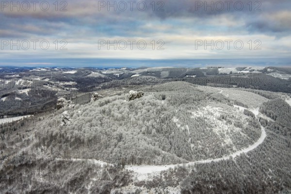 Aerial view of the rock formation Bruchhauser Steine a ground monument with four main rocks on the Istenberg in the Rothaargebirge in winter with snow in Bruchhausen in Olsberg in Sauerland in North Rhine-Westphalia, Germany, Sauerland, Europe, aerial view, birds-eyes view, aerial photography, aerial photography, overview, bird's eye view