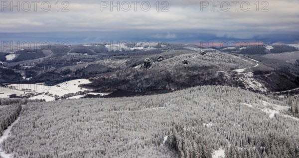 Aerial view of the rock formation Bruchhauser Steine a ground monument with four main rocks on the Istenberg in the Rothaargebirge in winter with snow in Bruchhausen in Olsberg in Sauerland in North Rhine-Westphalia, Germany, Sauerland, Europe, aerial view, birds-eyes view, aerial photography, aerial photography, overview, bird's eye view