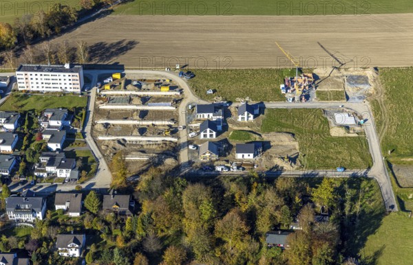 Aerial view, construction site and new construction of residential buildings on Breslauer Straße in Schmallenberg, Sauerland, North Rhine-Westphalia, Germany, construction work, construction area, building plots, construction project, construction site, DE, Europe, property tax, real estate, aerial view, aerial photography, aerial photography, new construction, Schmallenberg, overview, bird's eye view, residential complex, living and living, residential area, residential buildings, residential quality, residential neighbourhood, housing estate, birds-eyes view, overview, retaining walls
