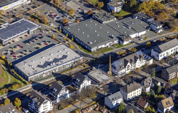 Aerial view, Olsberg employment agency and shopping centre and construction site with new building on the main road in the Bigge district of Olsberg, Sauerland, North Rhine-Westphalia, Germany, Aldi supermarket, construction work, construction area, construction site, building plots, construction crane, construction project, construction site, authority, DE, Europe, hit shopping centre, aerial view, aerial photography, aerial photography, new building, Olsberg, Rossmann drugstore, overview, bird's eye view, bird's eye view, overview