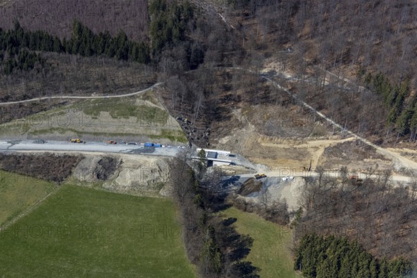 Aerial view, construction site and new construction of the L776n bypass Bad Fredeburg, Fredeburg, Schmallenberg, Sauerland, North Rhine-Westphalia, Germany, construction work, construction, construction area, construction site, building plots, construction project, construction site, bridge, DE, relief of the through road, Europe, state road L776n, aerial view, aerial photography, aerial photography, new construction, bypass, overview, bypass road, bird's-eye view, forest area, residential area, birds-eyes view, overview