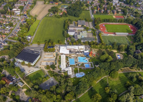 Aerial view, construction site and new construction of an indoor swimming pool at the Rheine outdoor swimming pool, Rheine ice rink, Kopernikus Gymnasium, Rheine evening high school and Jahnstadion in Rheine-Stadt in Rheine, Münsterland, North Rhine-Westphalia, Germany, bathing establishment, bathing resort, construction work, construction area, building site, building plots, construction measure, construction project, construction site, education, educational institution, DE, ice rink, Europe, outdoor swimming pool, football pitch, football stadium, grammar school, indoor swimming pool, educational institute, aerial view, aerial photography, aerial photography, new building, Rheine, school, swimming pool, sports, sports facilities, sports field, sports facility, overview, bird's-eye view, overview