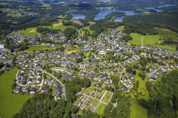 Aerial view, local view Rhode, catholic primary school Franz-Hitze-Schule, church St. Cyriakus, Olpe, Sauerland, North Rhine-Westphalia, Germany, place of worship, burial site, Biggesee, education, educational institution, DE, Europe, cemetery, memorial, religious community, churchyard, place of worship, primary school, land tax, graves, burial ground, sacred site, hilly landscape, real estate, church, parish, denomination, educational institute, aerial view, aerial photography, aerial photography, local view, religion, religious site, resting place, school, townscape, urban area, overview, bird's-eye view, housing estate, housing and living, residential area, residential buildings, housing quality, housing estate, birds-eyes view, overview