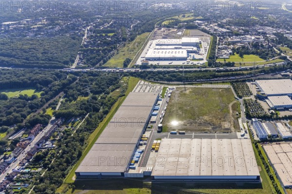 Aerial view, SEGRO Logistics Park Oberhausen, Edeka central warehouse Oberhausen and Sterkrade colliery with historic winding tower in the background in the Waldteich industrial park in the Holten district of Oberhausen, Ruhr area, North Rhine-Westphalia, Germany, DE, Europe, commercial enterprises, commercial area, industrial park, Waldteich industrial park, commercial location, commercial use, freight traffic, industrial area, industrial building, industrial location, logistics, logistics service, logistics service provider, logistics provider, logistics centre, aerial view, aerial photography, aerial photography, Oberhausen, SEGRO Parks, transport service, overview, bird's eye view, colliery, birds-eyes view, overview