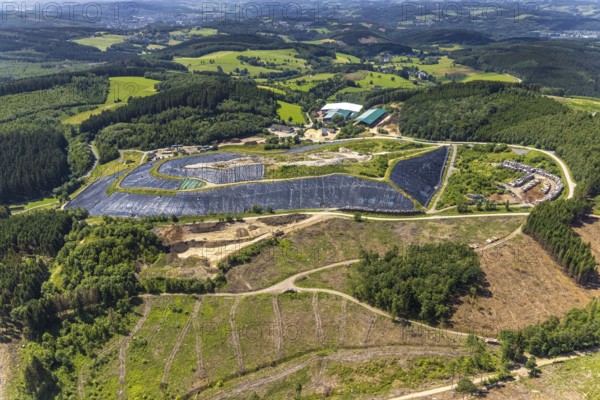 Aerial view, forest area with forest damage and clear cutting, area covered with plastic tarpaulins of the landfill Olper Entsorgungszentrum GmbH, Oberveischede Unterneger, Oberveischede, Olpe, Sauerland, North Rhine-Westphalia, Germany, waste, bark beetle plague, DE, landfill* Germany, drought, Europe, spruce dieback, aerial view, aerial photograph, dump, hilly landscape, compost, composting plant Olpe, storage, aerial photograph, aerial photography, aerial photography, aerial photography, waste, Neuenwald, recycling, recycling centre, collection point, drought, overview, sealing, recycling, bird's-eye view, forest damage, forest damage, lack of water, birds-eyes view, overview