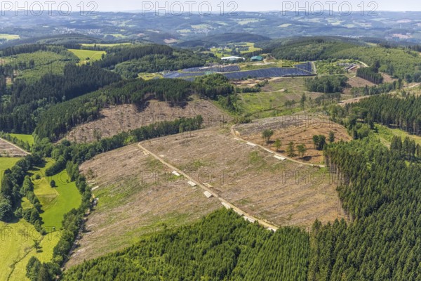 Aerial view, forest area with forest damage and clear cutting, area covered with plastic tarpaulins of the landfill Olper Entsorgungszentrum GmbH, Oberveischede Unterneger, Oberveischede, Olpe, Sauerland, North Rhine-Westphalia, Germany, waste, tree mortality, tree trunks, bark beetle plague, DE, landfill* Germany, drought, Europe, spruce mortality, aerial photograph, aerial view, aerial photography, aerial dump, hilly landscape, clear-cut, clear-cutting, compost, composting plant Olpe, storage, aerial photograph, aerial photography, aerial photography, aerial photography, waste, Neuenwald, recycling, recycling centre, collection point, drought, overview, sealing, recycling, bird's-eye view, forest, forest area, forest damage, forest damage, forest dieback, water shortage, birds-eyes view, overview