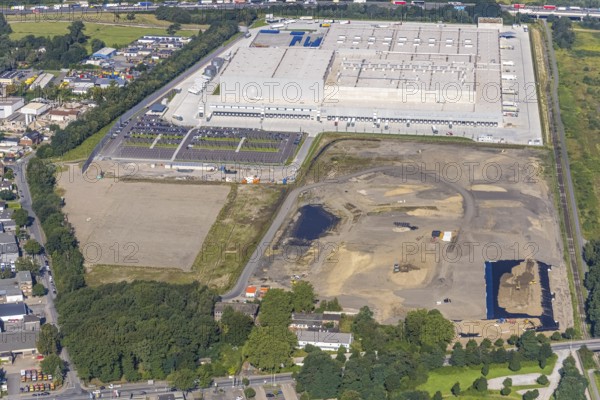 Aerial view, Edeka central warehouse Oberhausen with fallow land in the industrial park Waldteich in the district Schwarze Heide in Oberhausen, Ruhr area, North Rhine-Westphalia, Germany, motorway A3, construction area, building site, building plots, DE, Europe, commercial enterprises, commercial area, industrial park, commercial location, commercial use, freight traffic, industrial area, industrial building, industrial site, logistics, logistics service, logistics service provider, logistics provider, logistics centre, aerial view, aerial photography, aerial photography, Oberhausen, transport service, overview, bird's-eye view, overview