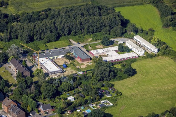 Aerial view, construction site and new building at the municip. Day care centre Holten in Oberhausen, Ruhr area, North Rhine-Westphalia, Germany, construction work, construction area, building site, building plots, construction crane, construction project, construction site, DE, Europe, kindergarten, day care centre, day care centre, day care centre, aerial photograph, aerial photography, aerial photography, new building, Oberhausen, overview, bird's-eye view, overview