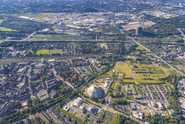 Aerial view, OLGA Park with ASO Oberhausen senior citizens' residence at OLGA Park, winding tower and old Steigerhaus as well as garden dome, in the background the Centro Oberhausen shopping centre in Osterfeld in Oberhausen, Ruhr area, North Rhine-Westphalia, Germany, DE, shopping centre, shopping mall, shopping mile, shopping markets, shopping place, shopping centre, Europe, leisure park, culture, art, aerial view, aerial photography, aerial photography, Oberhausen, park, shopping, shopping centre, overview, event location, event venue, event centre, bird's-eye view, birds-eyes view, former Osterfeld colliery and coking plant, cultural use, overview
