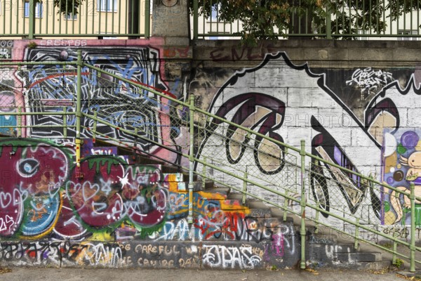 Diverse graffiti with lettering on a concrete wall next to a staircase, Am Donaukanal Innere Stadt Vienna Austria