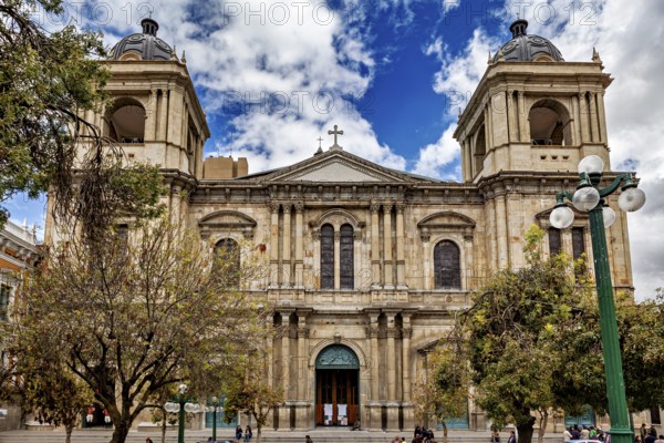 Historic cathedral with imposing façade and towers under a cloudy sky in an urban setting, A church in La Paz Bolivia