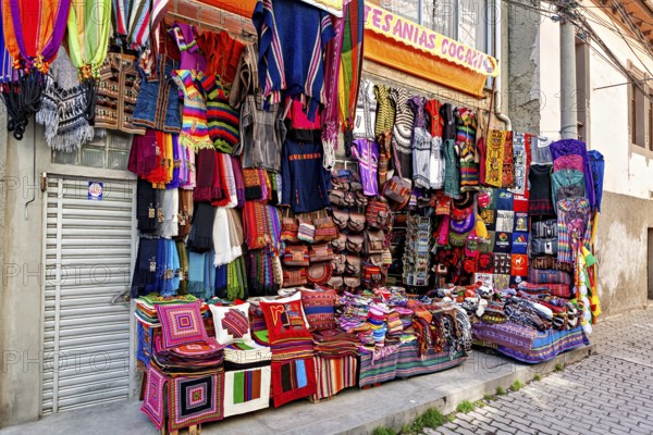 A market stall with colourful, handmade textiles and artistically designed fabrics at a lively street market, souvenir shops in La Paz Bolivia