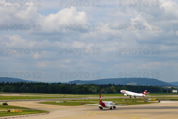 Swiss Airlines Passenger Airplane Take Off From the Runway and Flying Against Blue Sky and Clouds in a Sunny Summer Day From the Airport in Kloten, Zurich, Zurich Canton, Switzerland