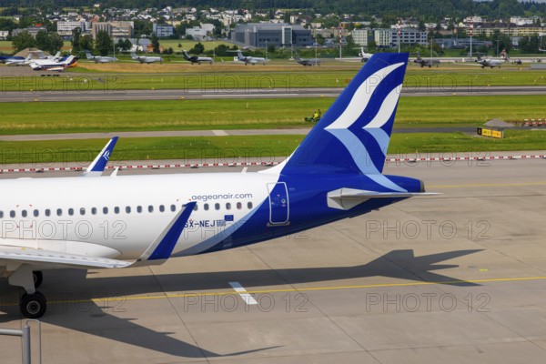 Aegean Airlines Passenger Airplane Taxiing on Runway in a Sunny Summer Day From the Airport in Kloten, Zurich, Zurich Canton, Switzerland