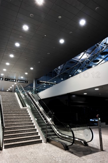 Inside Illuminated Zurich Airport with Escalator at Night in the Airport in Kloten, Zurich, Zurich Canton, Switzerland