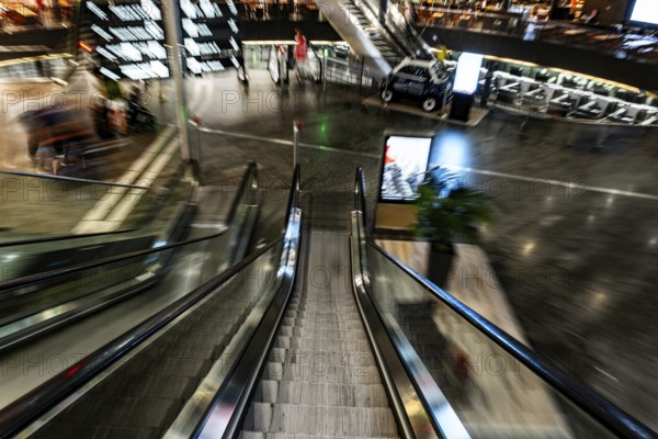 Inside Illuminated Zurich Airport with Escalator in Blurred Motion at Night in the Airport in Kloten, Zurich, Zurich Canton, Switzerland