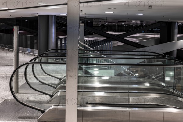Inside Illuminated Zurich Airport with Escalator at Night in the Airport in Kloten, Zurich, Zurich Canton, Switzerland