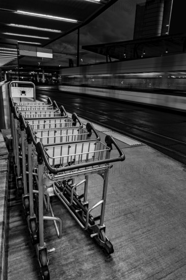 Many Luggage Trolley on Railroad Station in Circle in Zurich Airport at Dusk in Kloten, Zurich, Zurich Canton, Switzerland