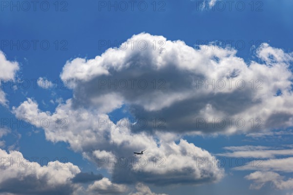 Passenger Airplane Flying Against Blue Sky and Clouds in a Sunny Summer Day From the Airport in Kloten, Zurich, Zurich Canton, Switzerland