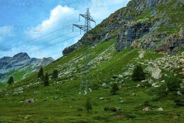 Electricity Pylon with Mountain View in the Swiss Alps in a Sunny Summer Day in Bernina, Valposchiavo, Pontresina, Grisons, Switzerland