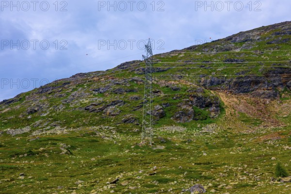 Electricity Pylon with Mountain View in the Swiss Alps in a Sunny Summer Day in Bernina, Valposchiavo, Pontresina, Grisons, Switzerland