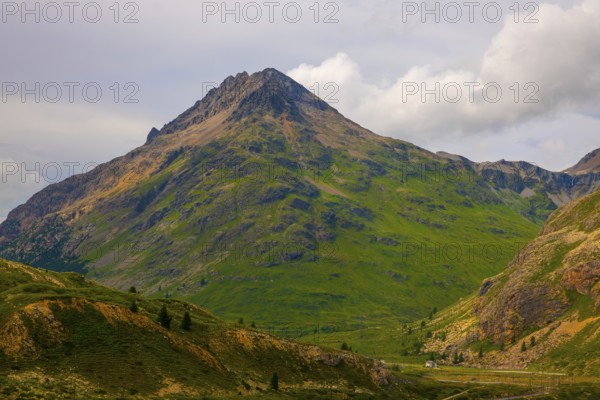 House and a Mountain Peak in the Swiss Alps in a Sunny Summer Day in Diavolezza, Corvatsch, Bernina, Valposchiavo, Pontresina, Grisons, Switzerland