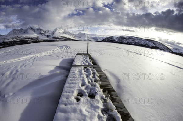 Norway tromsö snow mountains lake jetty frozen
