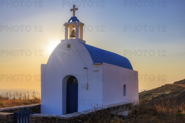Golden dawn over Serifos. A serene sunrise illuminates the timeless beauty of a Greek Island chapel, Cyclades Islands, Greece