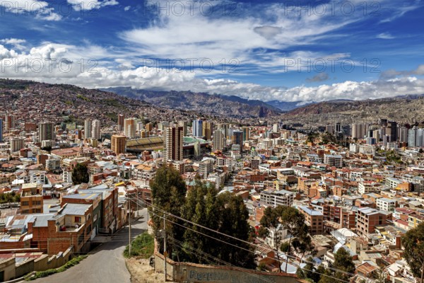 Panoramic view over La Paz with skyscrapers in front of a mountain landscape under a blue sky, The houses and skyscrapers of the city centre of La Paz in Bolivia