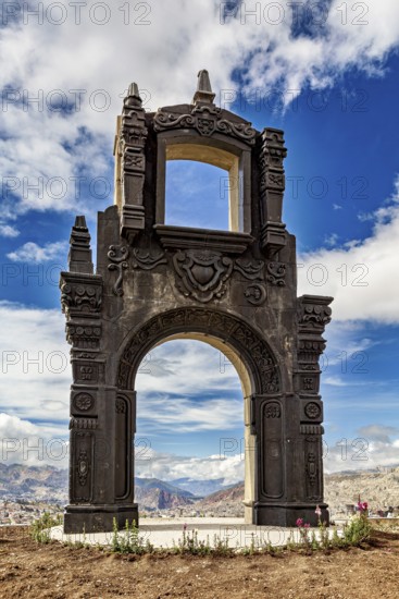 An imposing stone gate with fine details under a dramatic cloudy sky, The gate at the Killi Killi viewpoint in La Paz, Bolivia