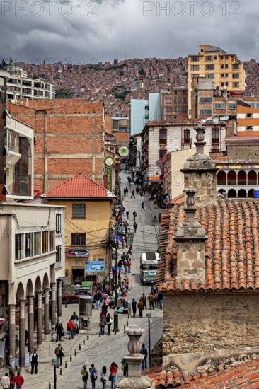 Lively city scene with tiled roofs and people on a street promenade, people in the streets of La Paz in Bolivia