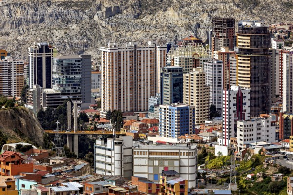 Modern high-rise buildings in an urban environment against a mountain backdrop, The houses and skyscrapers of the city centre of La Paz in Bolivia