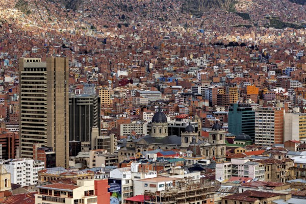 Urban landscape with cathedral in front of mountains and dense houses, The houses and skyscrapers of the city centre of La Paz in Bolivia