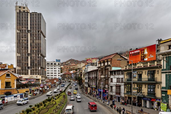 Busy urban street with skyscrapers and billboards, surrounded by mountains and cloudy skies, The main streets in the city centre of La Paz in Bolivia