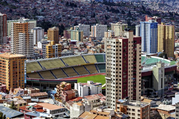 Cityscape with a large stadium surrounded by skyscrapers, The houses and skyscrapers of the city centre of La Paz in Bolivia