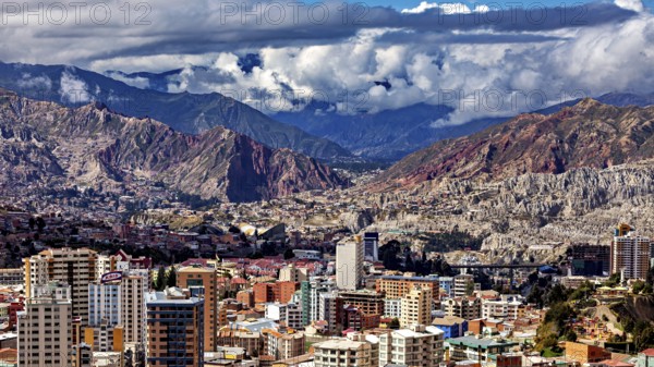 Panorama of a city surrounded by mountains and under a cloud cover, The houses and skyscrapers of the city centre of La Paz in Bolivia