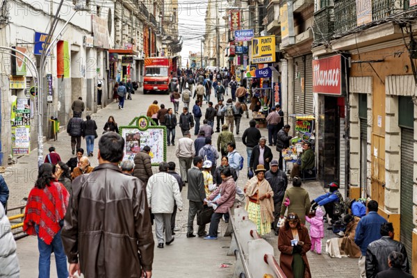 Busy street in a city with many people and shops in La Paz, people in the city centre of La Paz in Bolivia