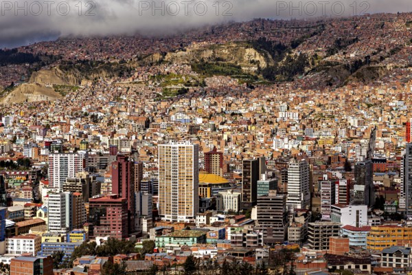 Dense cluster of houses of La Paz embedded in a hilly landscape, The houses and skyscrapers of the city centre of La Paz in Bolivia