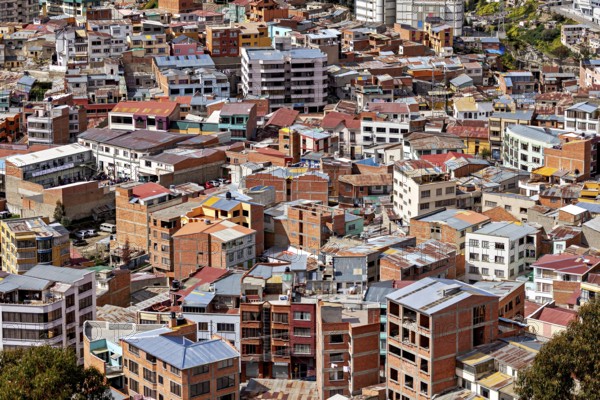 Dense cluster of houses with colourful roofs, The houses and skyscrapers of downtown La Paz in Bolivia