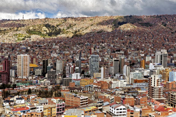 Dense development of a city with many high-rise buildings and clouds, The houses and skyscrapers of the city centre of La Paz in Bolivia