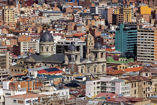 A cathedral surrounded by urban development, The houses and skyscrapers of the city centre of La Paz in Bolivia
