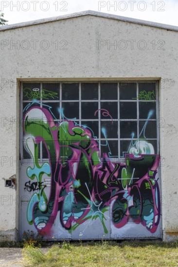 Garage door decorated with colourful graffiti and abstract shapes, at the port of Linz Upper Austria Austria