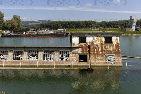 Rusty, dilapidated building on the water in a natural environment, at the harbour Linz Upper Austria Austria