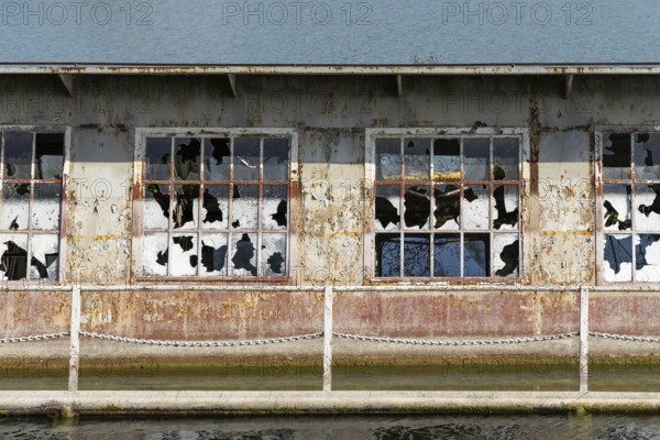 Close-up of broken windows of a rusty building on the waterfront, at the harbour of Linz Upper Austria Austria